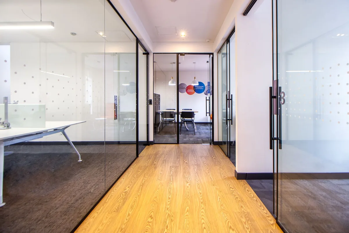 Bright office corridor with glass partition walls after completion of interior fit-out works