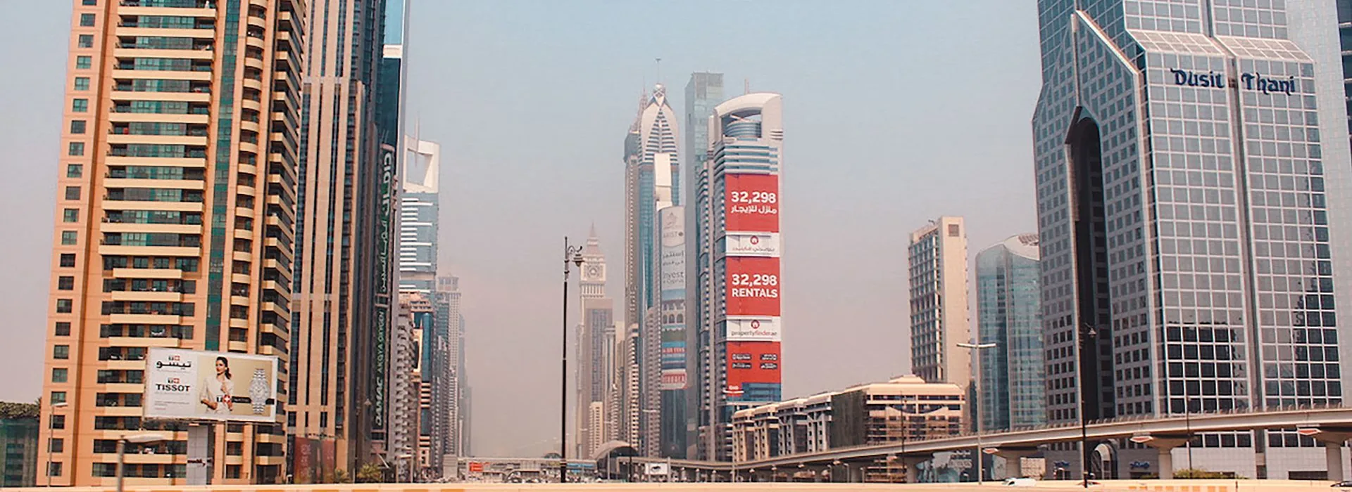 High-rise towers and an elevated highway along Sheikh Zayed Road in Dubai on a clear day