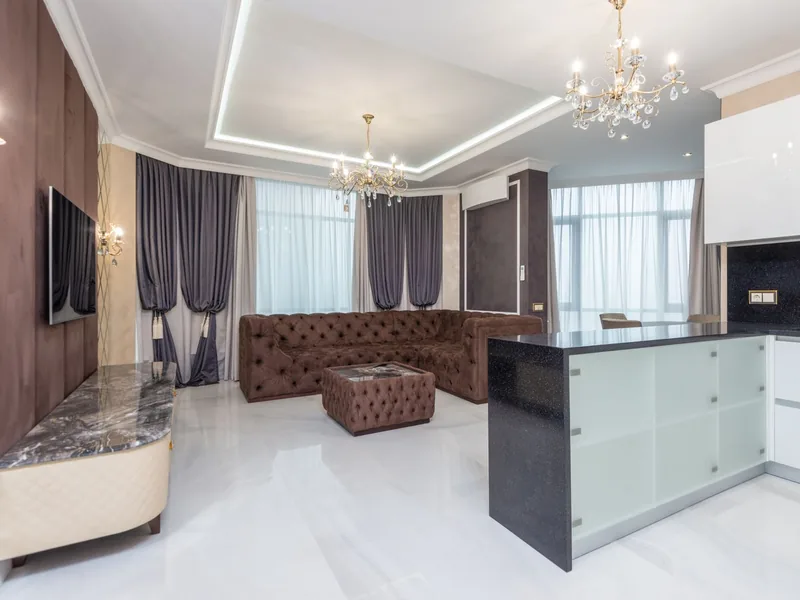 Spacious modern living room with chandeliers and contemporary furnishing after an interior fit-out